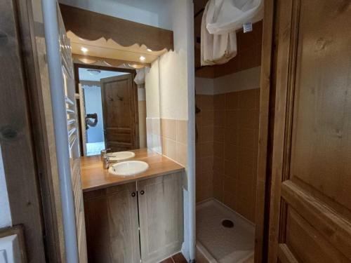 une salle de bain avec un lavabo et un miroir dans l'établissement Grand T3 plein sud avec garage couvert et accès direct aux pistes - FR-1-445-177, à Montgenèvre