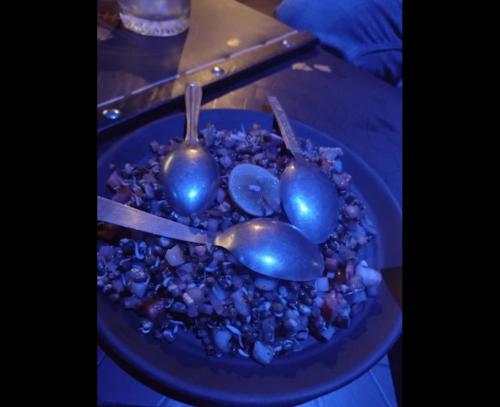 a blue plate of food with blue fruits and spoons at Hotel The Apex,Jaipur in Jaipur