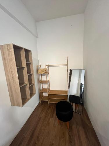 a room with a black chair and a shelf at instaspace in Bandung