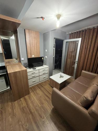 a living room with a couch and a flat screen tv at instaspace in Bandung