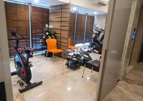 a gym with treadmills and exercise equipment in a room at Hotel Auris & Banquets, Mumbai International Airport in Mumbai