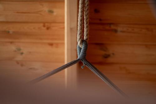 a cluster of ropes hanging from a ceiling at Osada Dębno 