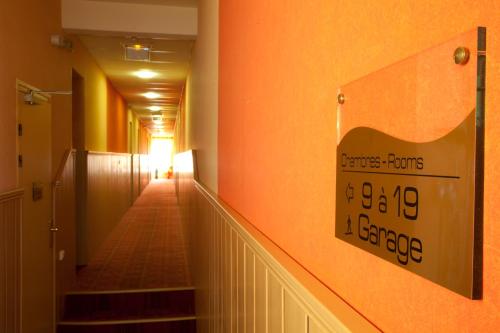 a hallway with stairs and a sign on the wall at Hotel Bristol in Châlons-en-Champagne