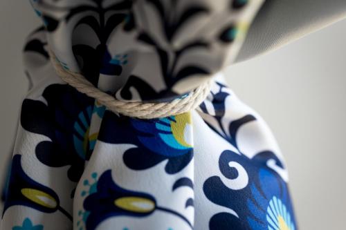 a close up of a blue and white tie with a rope at Osada Dębno 