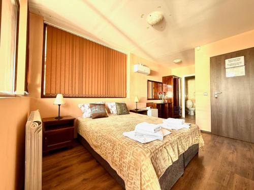 Postel nebo postele na pokoji v ubytování Family Hotel Carpe Diem
