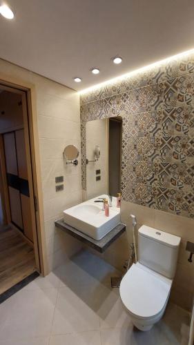 a bathroom with a toilet and a sink at Maison 7 New Cairo in Cairo