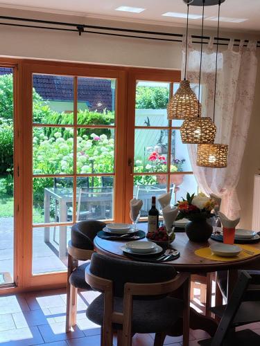 a dining room with a table and chairs and a window at Schwalbenweg in Zingst
