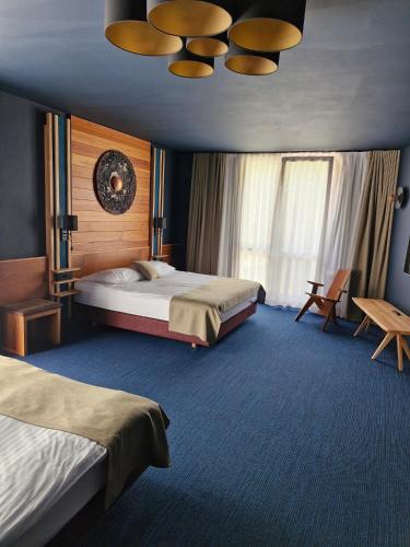 a hotel room with two beds and a table at Hotel Boka in Bovec
