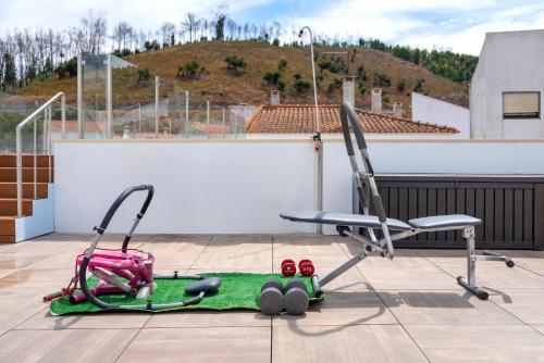 a chair sitting on top of a roof at AL-Odeceixe Verde in Odeceixe