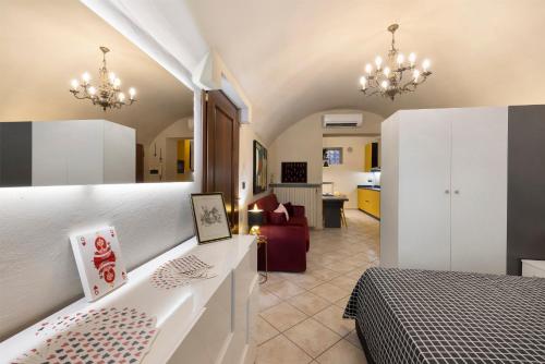 a bedroom with a bed and a living room at Il Cappellaio Matto in Alessandria