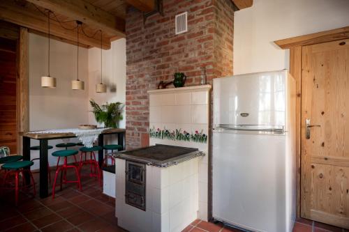a kitchen with a white refrigerator and a table at Osada Dębno 