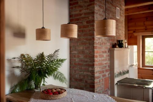 a kitchen with a table with a bowl of fruit on it at Osada Dębno 