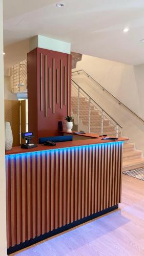 a colorful bar in a room with stairs at Hotel Milazzo Smart in Milazzo
