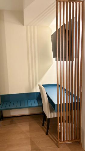 a blue desk and a white chair in a room at Hotel Milazzo Smart in Milazzo