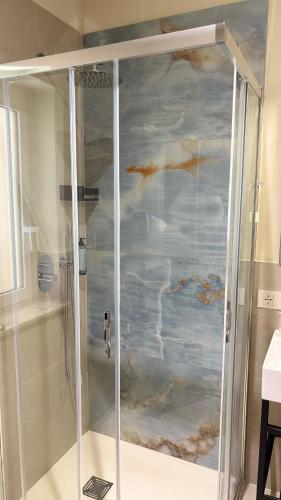 a shower stall with a painting of clouds at Hotel Milazzo Smart in Milazzo