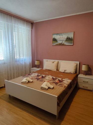 a bedroom with a large bed with towels on it at Villa Stefan in Ohrid