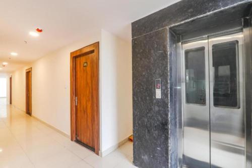 an empty hallway with a metal door in a building at RROOMS Rachna Inn in Lucknow