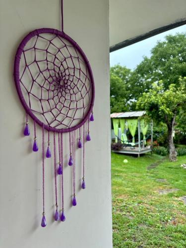 a dream catcher hanging on a wall at Cozy Family Home 