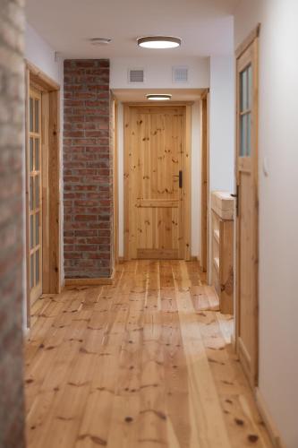 an empty room with a wooden floor and a door at Osada Dębno 