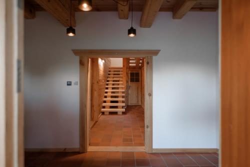 a hallway with a door leading into a room at Osada Dębno 