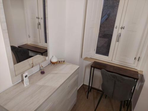 a kitchen with a counter with a mirror and a table at Al Monumento bed & breakfast in Amantea