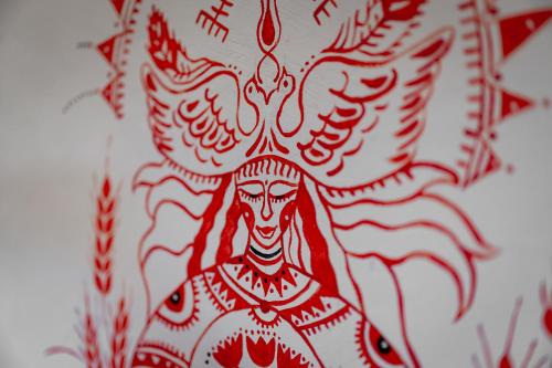 a drawing of a demon on a plate at Osada Dębno 