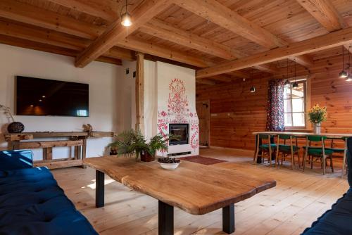 a living room with a table and a fireplace at Osada Dębno 
