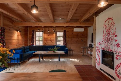 a living room with a blue couch and a fireplace at Osada Dębno 