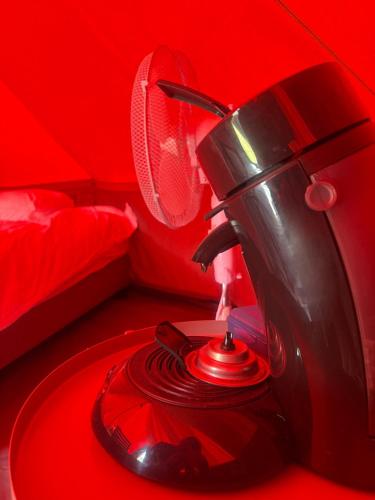 a red room with a red room with a fan at Glamping Dok52 in Bruges