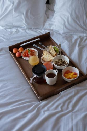 a tray of breakfast foods on a bed at Hotel & Spa Oceania Lille Les Augustins in Lille