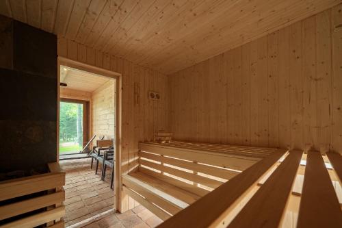 a large wooden room with a tub in it at Osada Dębno 