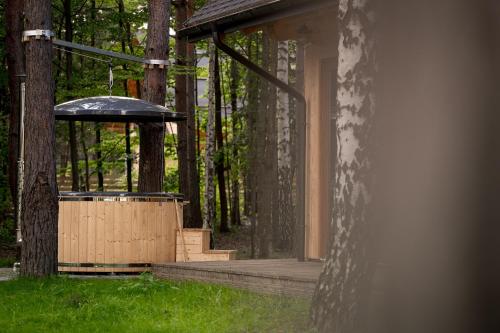 a building with a gazebo in the grass at Osada Dębno 