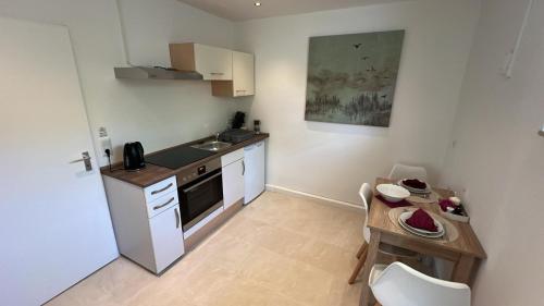 a small kitchen with a sink and a table at Kirchheim Hessen in Kirchheim