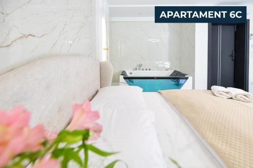a bedroom with a bed and a sink in a bathroom at Słoneczne Wzgórze Zator in Zator