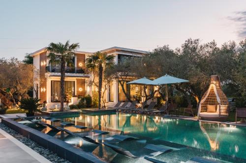 a house with a swimming pool with a house at Giardino Lux Apartments in Ulcinj