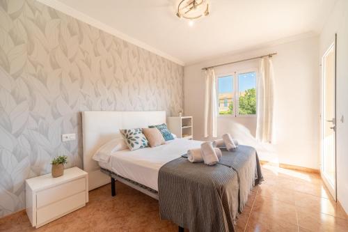 ein Schlafzimmer mit einem Bett und einem Fenster in der Unterkunft E327 Maristany by Mallorca Villa Selection in Alcúdia