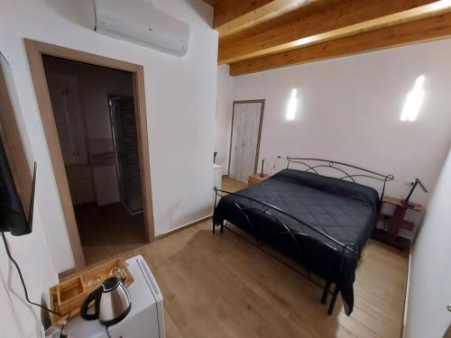 a bedroom with a black bed in a room at Al Monumento bed & breakfast in Amantea