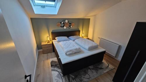 a bedroom with a bed with two pillows on it at Gailtaler Apartments Alinkhof in Bach