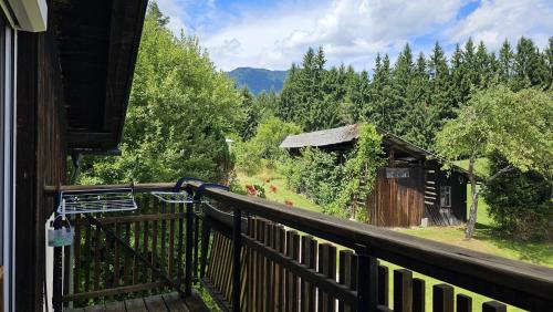 a balcony of a house with a view of a forest at Gailtaler Apartments Alinkhof in Bach