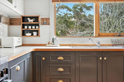 a kitchen with a sink and a window at Countryside Escape Near Margate Village in Margate