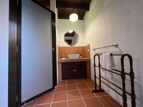 a bathroom with a sink and a mirror at East Indies Mansion in George Town