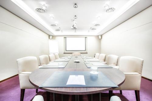 a large conference room with a long table and chairs at Marivaux Hotel in Brussels