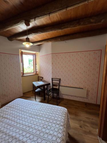 a bedroom with a bed and a table and a window at Rooms Poli Luce - Room Franica in Gračišće