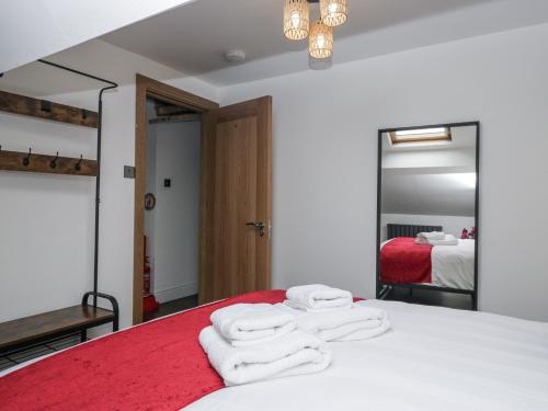 a bedroom with a bed with white towels on it at Aspen Boutique in Windermere