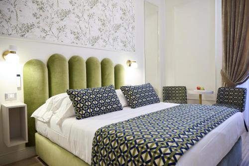 a bedroom with a large bed with two chairs at Stanze del David Place in Florence