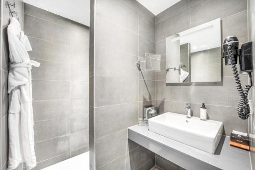 a bathroom with a sink and a mirror at Marivaux Hotel in Brussels