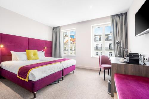 En eller flere senge i et værelse på Marivaux Hotel