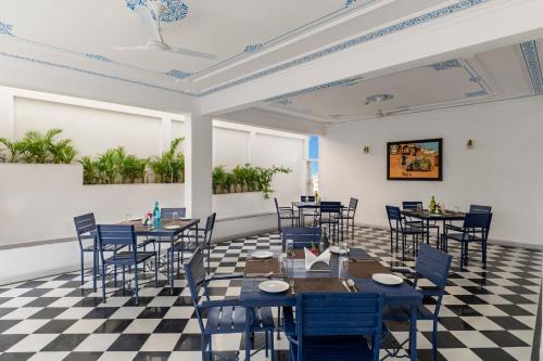 a room with tables and chairs and a checkered floor at Maan Vilas - A Boutique Hotel Udaipur in Udaipur