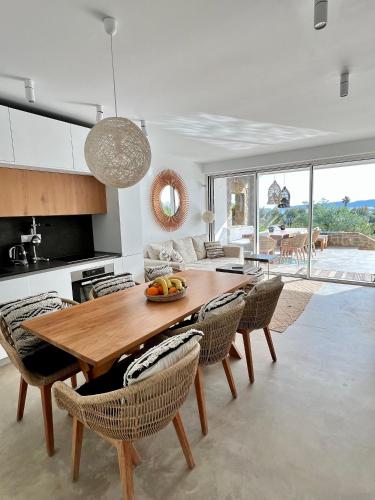 a kitchen and dining room with a wooden table and chairs at VistaWave Sea View Villa in Gialova