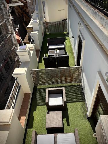 an overhead view of a building with a courtyard with benches at Hotel Plaza in Seville